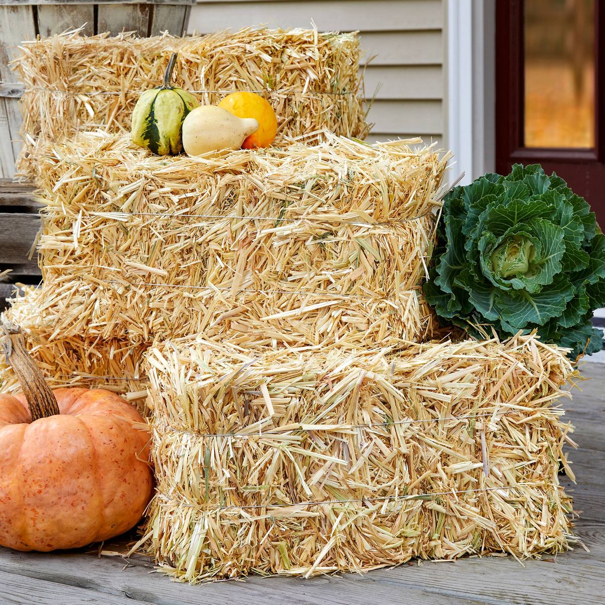 Stack of hay bales with pumpkins and gourds on a wooden surface in Westport Fairfield County CT Connecticut
